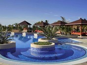 pool with red loungers around under roof